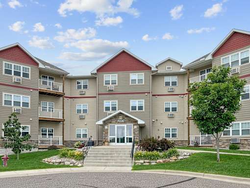an exterior view of an apartment building with stairs
