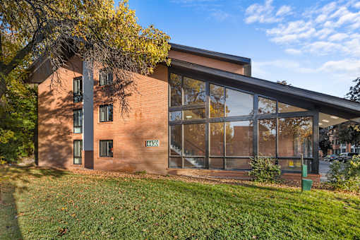 the exterior of a brick building with large glass windows