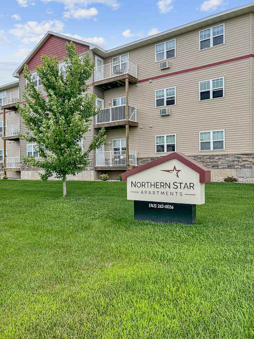 A building with a sign that says Northern Star Apartments in front of it.