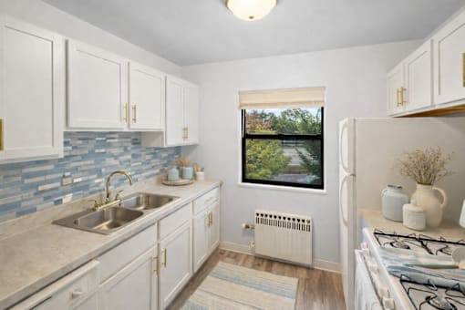 A kitchen with a window overlooking a bridge.