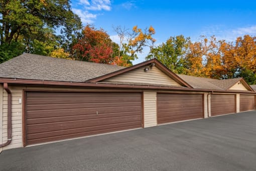 A house with a brown garage door and a grey roof.