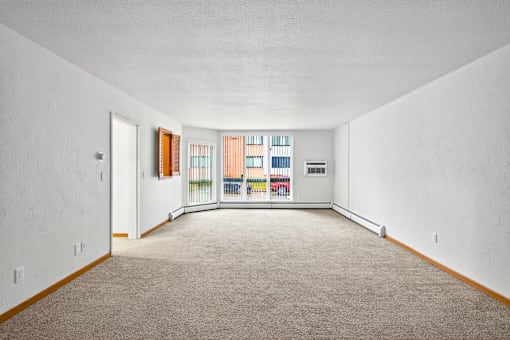 A room with white walls and a carpeted floor.