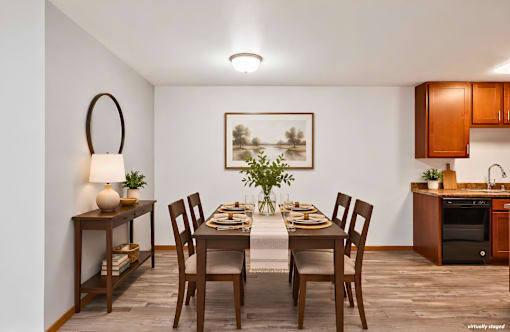 A dining room with a table set for a meal.