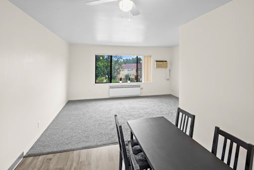 A dining room with a table and chairs.