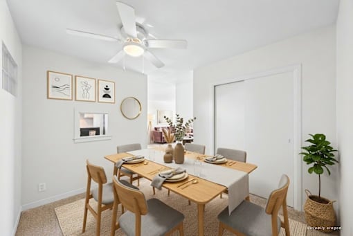 A dining room with a table set for six people.