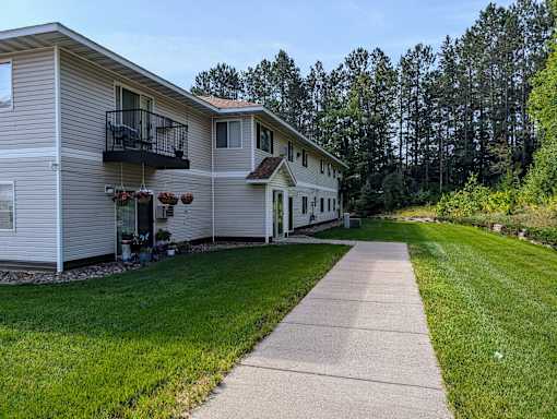 A residential area with a house and a walkway.