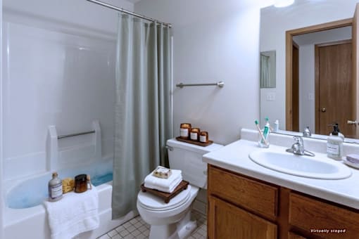 A white bathroom with a toilet, sink, and bathtub.
