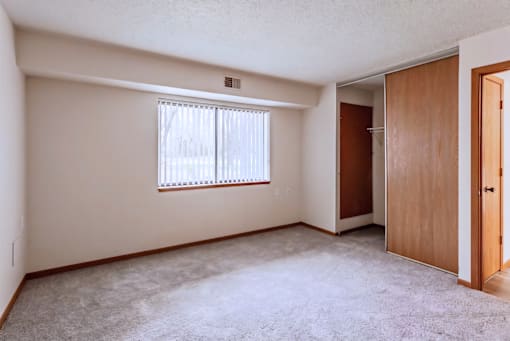 A room with a window and a door.