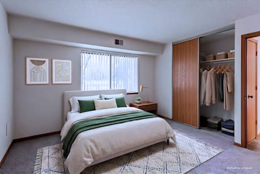 A bedroom with a large bed and a wardrobe.