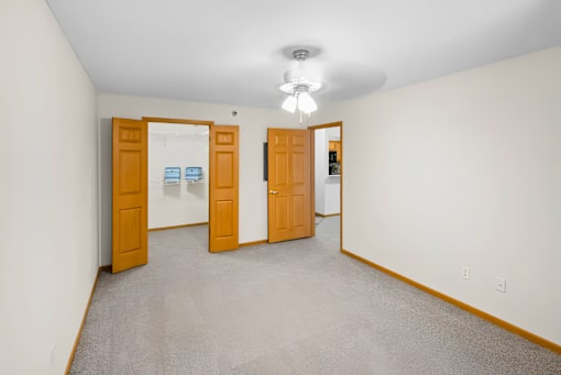 A room with two doors and a carpeted floor.