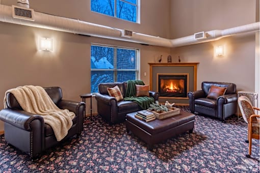 A cozy living room with a fireplace and comfortable seating.