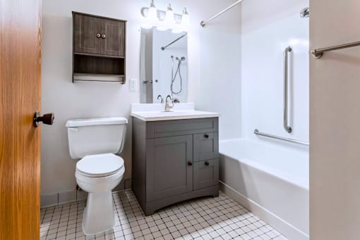 A white toilet sits next to a sink in a small bathroom.