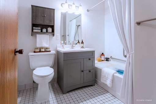 A bathroom with a white toilet and a white sink.