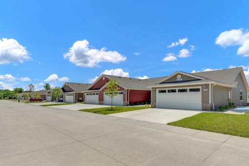 a house with a driveway and two garage doors