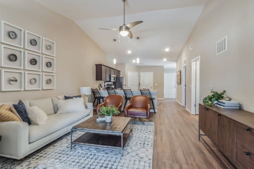 a living room with a couch and chairs and a table