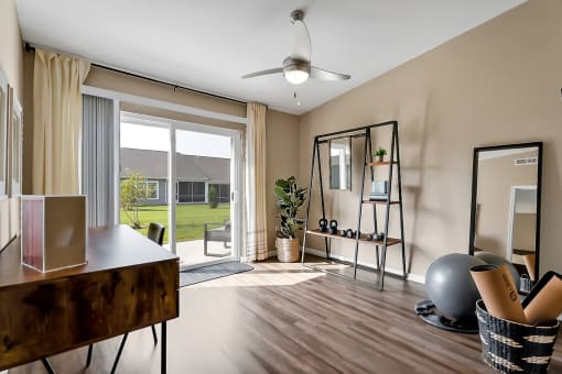 a living room with a mirror and a sliding glass door