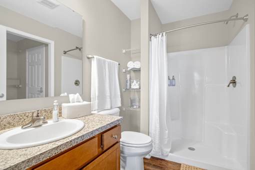 A bathroom with a sink, toilet, and bathtub.