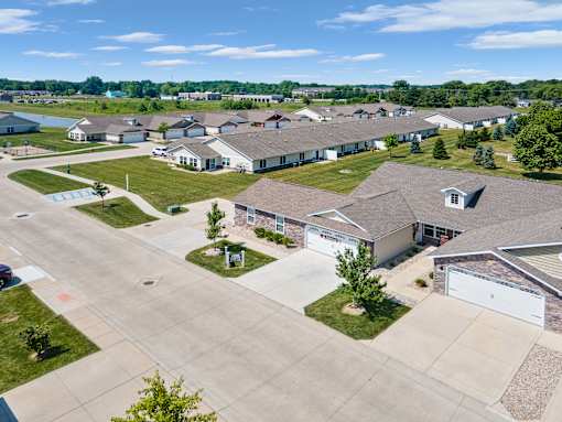 A bird's eye view of a residential area with houses and driveways.