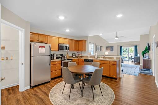 A kitchen with a table and chairs in the middle of the room.