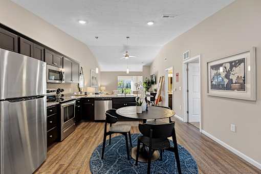 A modern kitchen with a dining table and chairs.