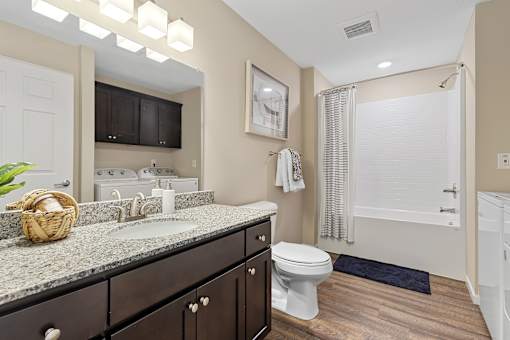 A bathroom with a toilet, sink, and shower.