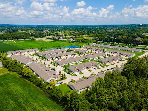 A bird's eye view of a residential area with houses and greenery.
