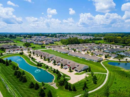 A bird's eye view of a residential area with houses and two lakes.
