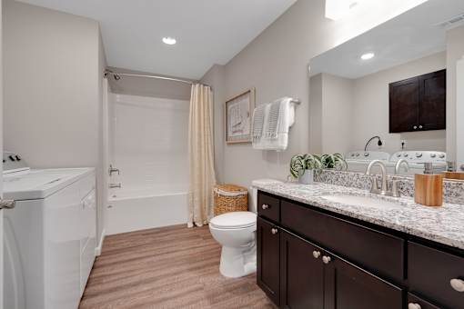 A bathroom with a washer and dryer built in.