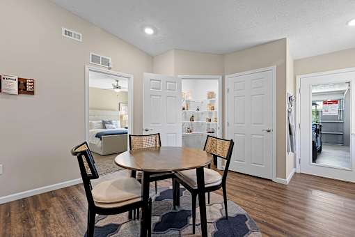 A dining room with a table and chairs.