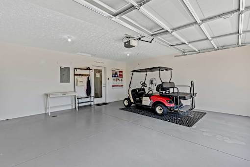 A golf cart is parked in a large, empty room.