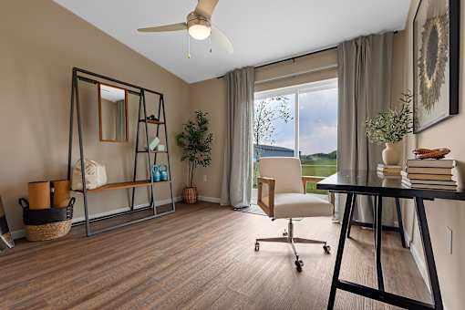 A room with a wooden floor and a ceiling fan.