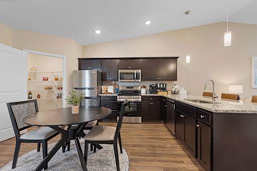A modern kitchen with a table and chairs.