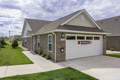 A two-story house with a garage labeled "Redwood Estates.".