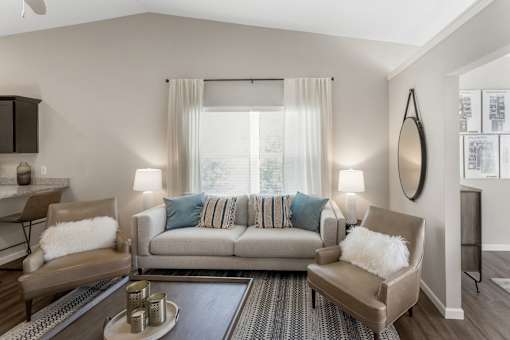 A living room with a grey couch and a coffee table.