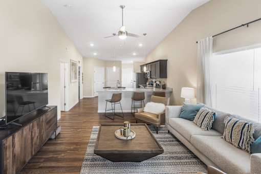 A modern living room with a television, couch, and coffee table.