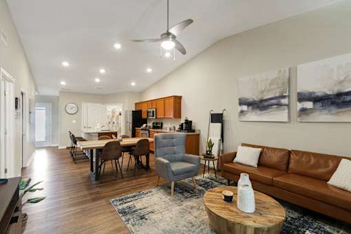 A living room with a brown leather couch and a wooden coffee table.