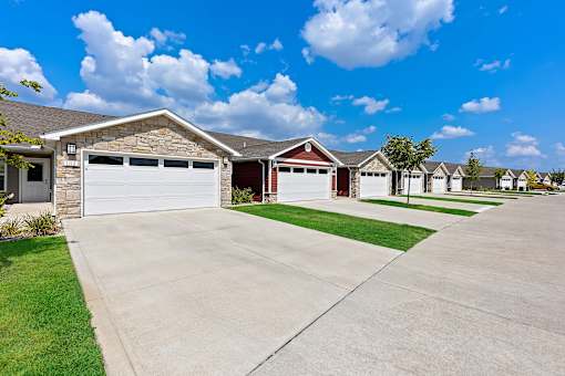 A row of houses with garages in front.