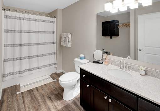 A bathroom with a white toilet, a sink, and a shower curtain.