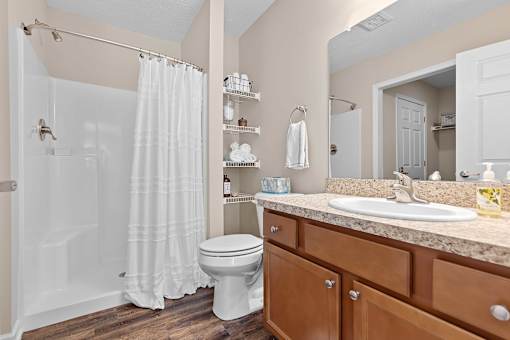 A bathroom with a white toilet and a white shower curtain.