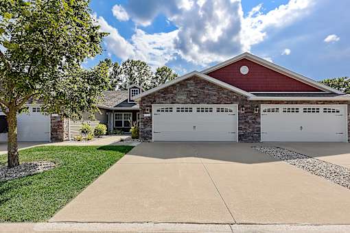 A red barn-style house with a white garage door.