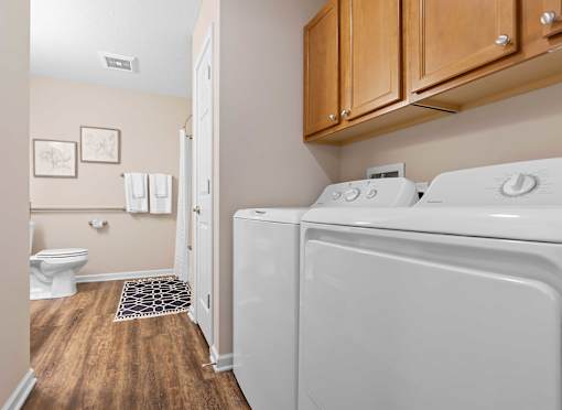 A white washing machine and dryer in a laundry room.