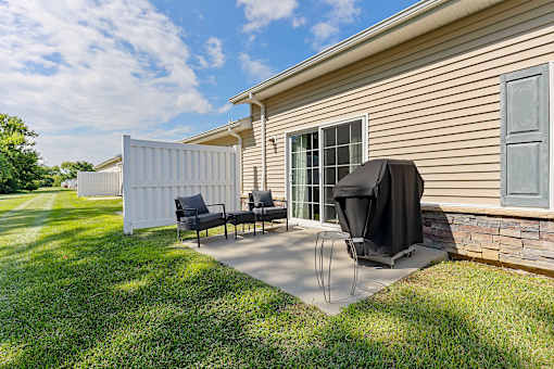 A house with a patio and a grill.