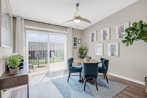 A dining room with a table set for four.