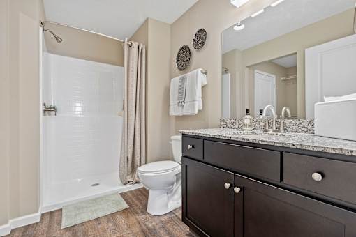 A bathroom with a toilet, sink, and shower.