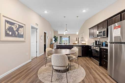 A kitchen with a table and chairs in the middle of the room.