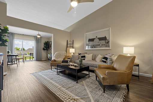 A living room with a brown leather chair and a grey and white rug.