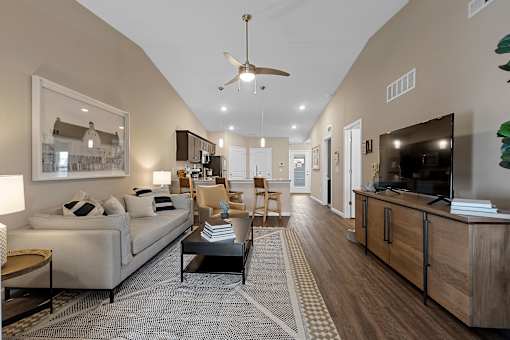 A living room with a couch, a coffee table, and a television.