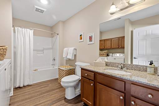 A bathroom with a toilet, sink, and bathtub.