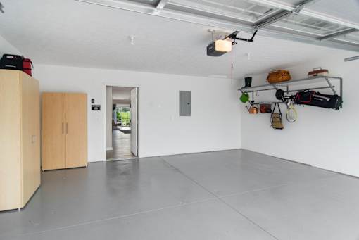 A room with a white wall and a grey floor.