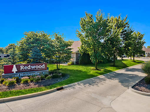 A sign for Redwood of Noblesville is in front of a building.